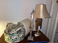 Lot contents with parking meter lamp, two candle holders, crystal chandelier inside floral box.