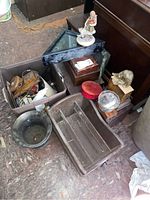 Overall lot showing wooden magazine rack, figurines, boxes, and frame.