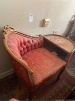 Full view of vintage wooden telephone bench showing tufted floral upholstery and carved floral wooden frame.