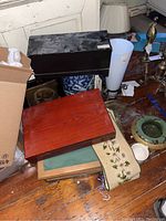 Overview of wooden boxes, shelf, flatware box, and portable writing desk on wooden floor