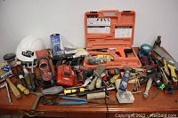 Overview of assorted tools including Hilti charger, Milwaukee drill driver, Makita angle grinder and hand tools
