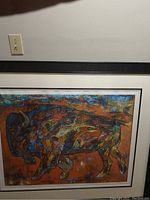 Framed abstract painting of a bull in colorful mosaic style with vivid colors and dark outlines.