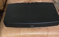 Top view of black Bose speaker showing smooth surface