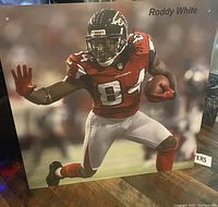 Full view of the large Roddy White image mounted/placed at an angle on a wood surface to show size and detail.