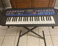 Front view of Casio CTK-400 keyboard on stand, showing full keyboard and control panel.
