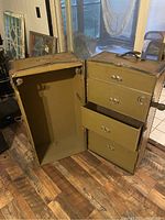 Open view of the vintage mobile closet trunk showing the empty main compartment and three drawers with metal handles.