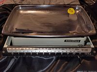 Front shot of the vintage Soehnle sliding kitchen scale showing the measurement bar and chrome tray.