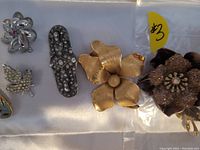 Close-up of pins showing details of the flower, leaf, and decorative designs