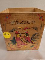 Front view showing folk art hand painted rooster and floral design with the word "FLOUR" on wooden box.