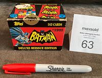 Front and top view of the original factory box with vintage Batman artwork, Topps branding, and text noting 143 cards and deluxe reissue edition. Includes red Sharpie for scale.