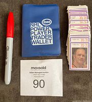 Blue Esso NHL Power Player Trader Wallet closed beside a Sharpie and pile of stamps