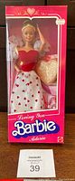 Front view of the unopened Barbie box showing doll and heart shaped accessory.