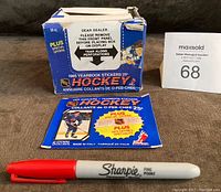 Photo of the blue box showing wear and tear, labeled 1985 Yearbook Stickers with NHL logos and pack count.