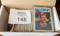 Box of cards with Brett Hull rookie visible and stack of cards