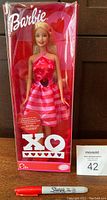 Front view of unopened Barbie XO doll in original box showing full doll and packaging with red Sharpie marker for scale.