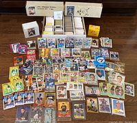 Wide shot of multiple boxes and loose cards spread out on floor