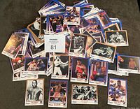Overview of numerous boxing cards spread out showing variety and quantity in the lot.
