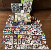 Full view of three boxes and binder pages with loose cards scattered on floor including numerous hockey players.