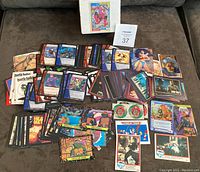 Spread of assorted non-sport collectible cards on surface including comic characters and various series