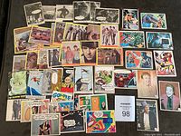 Full lot of 50 vintage non-sports cards spread out showing multiple series including Batman, The Monkees, Laugh In, Marvel Super Heroes and others.