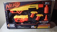 Front view of sealed Nerf Alpha Strike Mission Pack showing 4 blasters, darts, and two half-targets inside packaging.