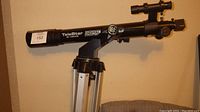 Side and angled views of the TeleStar telescope by Meade showing digital setting, finder scope, and tripod mount