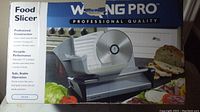 Photo of Waring Pro FS150 food slicer packaging showing product image and features.