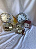 Full group of seven clocks including wall, desk, and decorative types