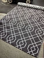 Exterior mat layout showing dark side with white geometric intersecting lines, fully unrolled.