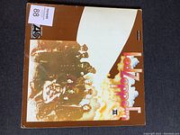 Front cover of Led Zeppelin II LP showing iconic brown and white album art with band image.