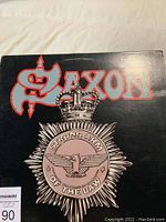 Front cover of SAXON Strong Arm of the Law LP showing band logo and emblem design.