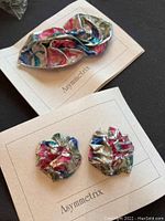 Colorful metallic multicolored and silver wavy, ruffled hair accessories and matching earrings on Asymmetrix cards