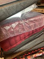 Multiple comfort cushions stacked and partially wrapped in plastic