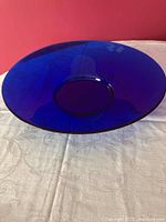 Top-down view of large cobalt blue shallow glass dish with a center base showing shape and color