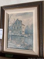 Full view of the framed oil painting depicting Bedford Mills in winter scene near water.