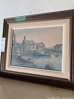 Framed original painting by James Lorimer Keirstead showing a maritime scene of fishing shacks and boats at a wharf in Sandford, Nova Scotia. Painting measures 20x16 inches.
