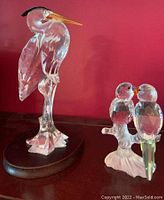 Both Swarovski bird figurines displayed side by side