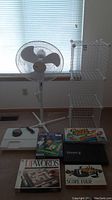 Full lot showing fan, storage cubes, nebulizer, and five board games including Mouse Trap, Snafu, Upwords, Score Four, and Conqueror chess set.
