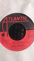 Close-up photo of Side One label showing the song "Self Control" by Laura Branigan under Atlantic Records label with red and black color scheme.