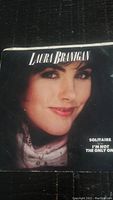 Front cover of the vinyl record sleeve showing Laura Branigan's face, and text indicating the songs Solitaire and I'm Not The Only One.