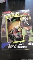 Box showing front of Teenage Mutant Ninja Turtles Christmas ornament with candy
