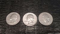 Three vintage American quarters from 1979 displayed on a dark textured surface, showing all heads sides facing left with visible wear and LIBERTY inscription.