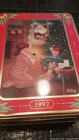 Full view of the top of the vintage 1992 Oreo Christmas cookie tin, showing the colorful holiday scene and year markings