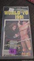 Front view of the WWF Wrestling VHS rental tape titled World '91 showing Hulk Hogan and Sgt. Slaughter on the cover with rental stickers on the plastic case.