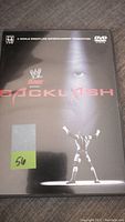 Front cover of WWF Wrestling DVD titled Backlash, showing wrestler raising hands and faint face in background.