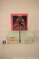 Two Madame Alexander doll boxes and 1991 Collectors Book in original packaging featuring traditional doll images on the cover