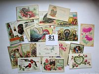 Top view of the lot laid out, showing a spread of 27 antique postcards with Thanksgiving and greeting themes, with lots of colorful vintage illustrations.