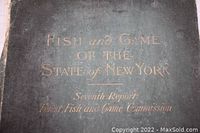 Close-up of folder cover showing title "Fish and Game of the State of New York Seventh Report Forest, Fish and Game Commission" embossed in gold on dark green paper.