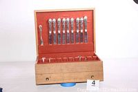 Wooden McGraw chest open showing arranged flatware upper tier and lower compartment