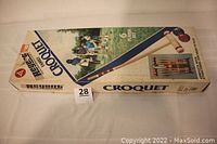 Photo of original box showing brand name Regent, croquet label, family playing image, and box condition.